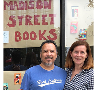 Two people standing in front of Madison Street Books